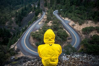 A person contemplating about what choice to make when faced with two uncertain paths both of which leads to uncertain future.