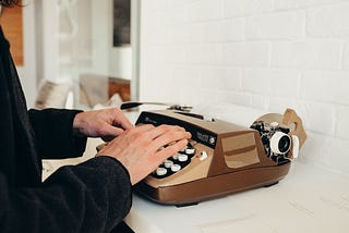 Picture of hands typing on a typewriter