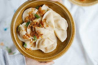 Dumplings on a plate which tragically haven’t been fried yet