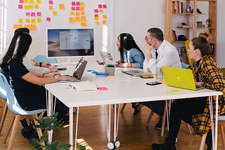 Designers gathered around a table working.