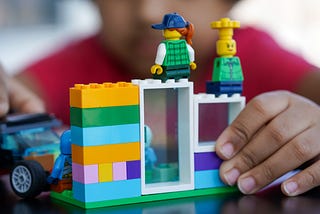 Photo of toy people sitting on a building made of Legos, by Ravi Palwe on Unsplash