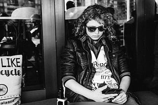 A young woman doom-scrolling on her phone
