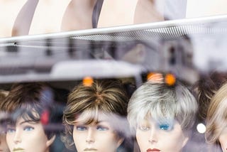 store window full of mannequin heads