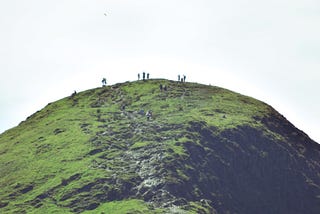 People standing at a peak of a mountain with no horizon in sight
