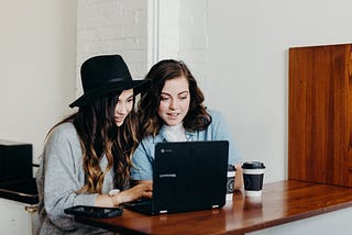 2 people using a computer