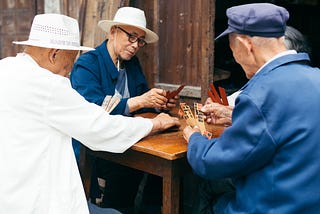 Old men at table playing a game