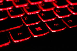 A red illuminated laptop keyboard, typical of a gaming laptop as used in casual bitcoin mining