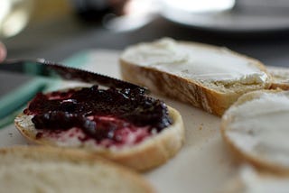 A picture of a cream cheese and grape jelly sandwich