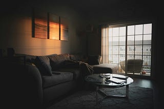 A gloomy room with a couch