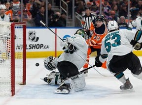 Edmonton Oilers' Ryan Nugent Hopkins (93) is stopped by San Jose Sharks goalkeeper Kabo Kahkkonen (34) during the first period of NHL games at Rogers Place in Edmonton, Thursday, March 24, 2022.