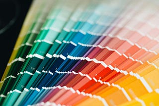 A full spectrum of paint swatches from green to yellow, symbolizing a rainbow
