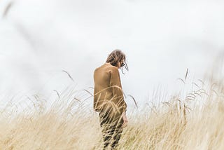 A person stands in a field.