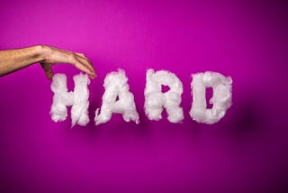 The word “Hard” on a pink background.