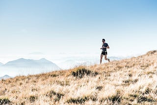 A man runs down a hill.