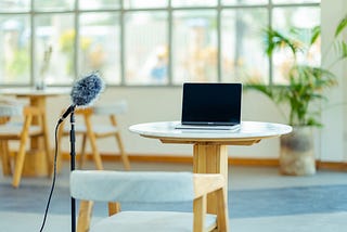 A simple laptop and a microphone setup for YouTubing — The environment looks tidy and serene.