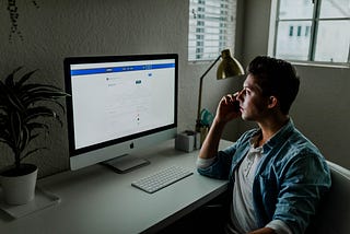 Virtual Mentor— guy in front of an IMAC