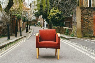 A chair in middle of the road