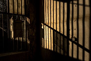 prison bars with light shining through