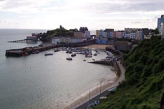 Tenby harbour — a beautiful view over-looking the harbour, with the pastel-painted houses and hotels curved around the shoreline