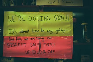 Green and red “we are closing” sign