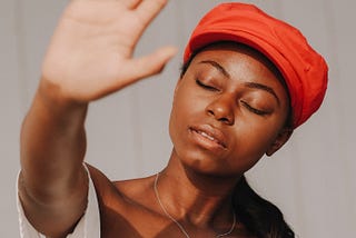 Girl in red hat, eyes closed who is frustrated with her daily gratitude practice.