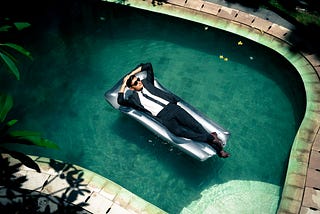 A person relaxing in a pool after using ChatGPT to make their life easier