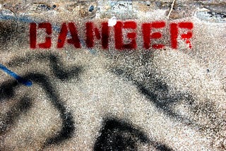 Image of the word “danger” written in red