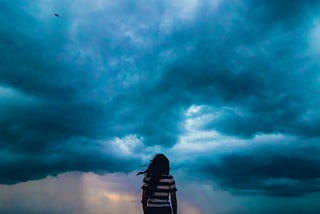 woman in striped shirt staring into storm