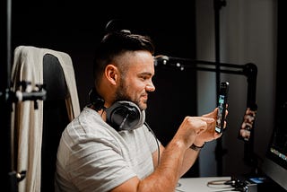 A man checking views on his mobile phone and is happy.