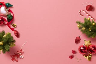 Photo of a blank pink canvas with greenery and ornaments.