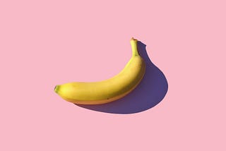 riped banana on pink surface