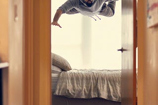 Man hovering over a bed