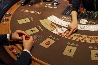 Man playing cards in a casino. Cards on top of casino table