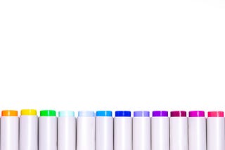 A row of pens inked in a variety of colours.