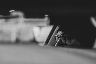 blurry image of someone sitting in a car