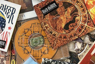 Kula Shaker CDs of singles and B-sides scattered in a pile; “Hush” CD most prominently featured in off-center top right