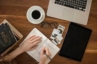 woman sitting at a desk writing