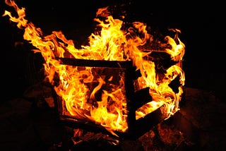 A wooden crate on fire.