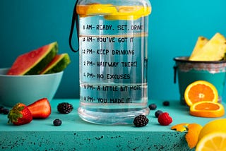 Product photography, motivational water bottle and fruits