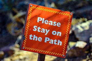 Sign reading ‘Please stay on the Path’