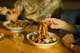 a couple sharing a chinese meal