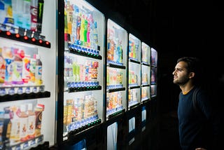 A person staring at vending machines