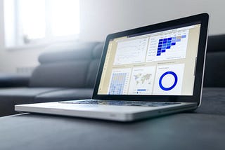 Data Analytics 101 — Basics of Data Analytics for Beginners: An image showing the laptop of a data analyst with graphs on a couch