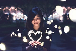 Girl holding a love symbol