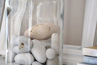 A glass jar with lots of big rocks