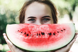 A lady with water-melon slice show excitement