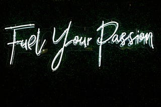 Lit neon sign that says “Fuel Your Passion”