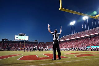 Referee raising hands as goal signal
