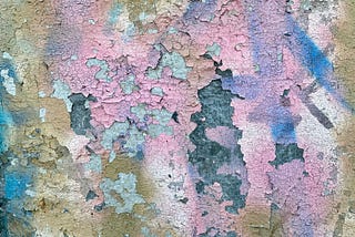 different colors of paint chipping from a wall