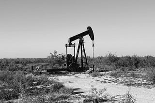 Oil derrick in a scrubby wasteland